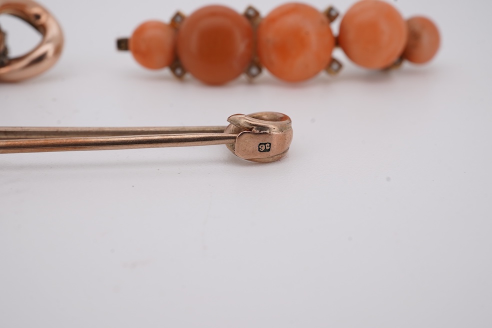 An early 20th century yellow metal and graduated five stone coral bead brooch, with seed pearl spacers, 45mm, together with a yellow metal curb link brooch and a yellow metal (stamped 9c) safety pin. Condition - fair